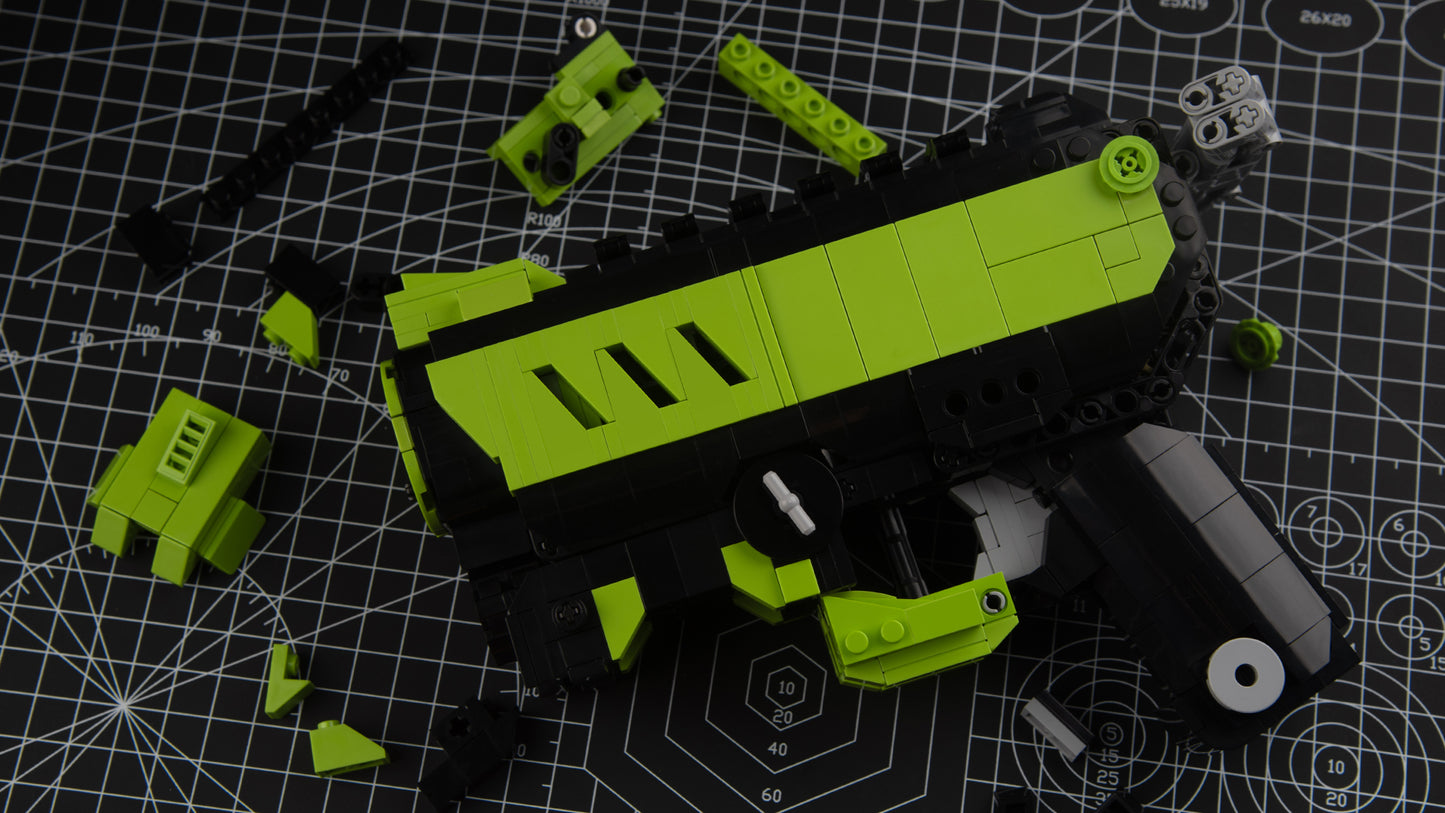 green phantom block gun blaster with scattered block parts on table
