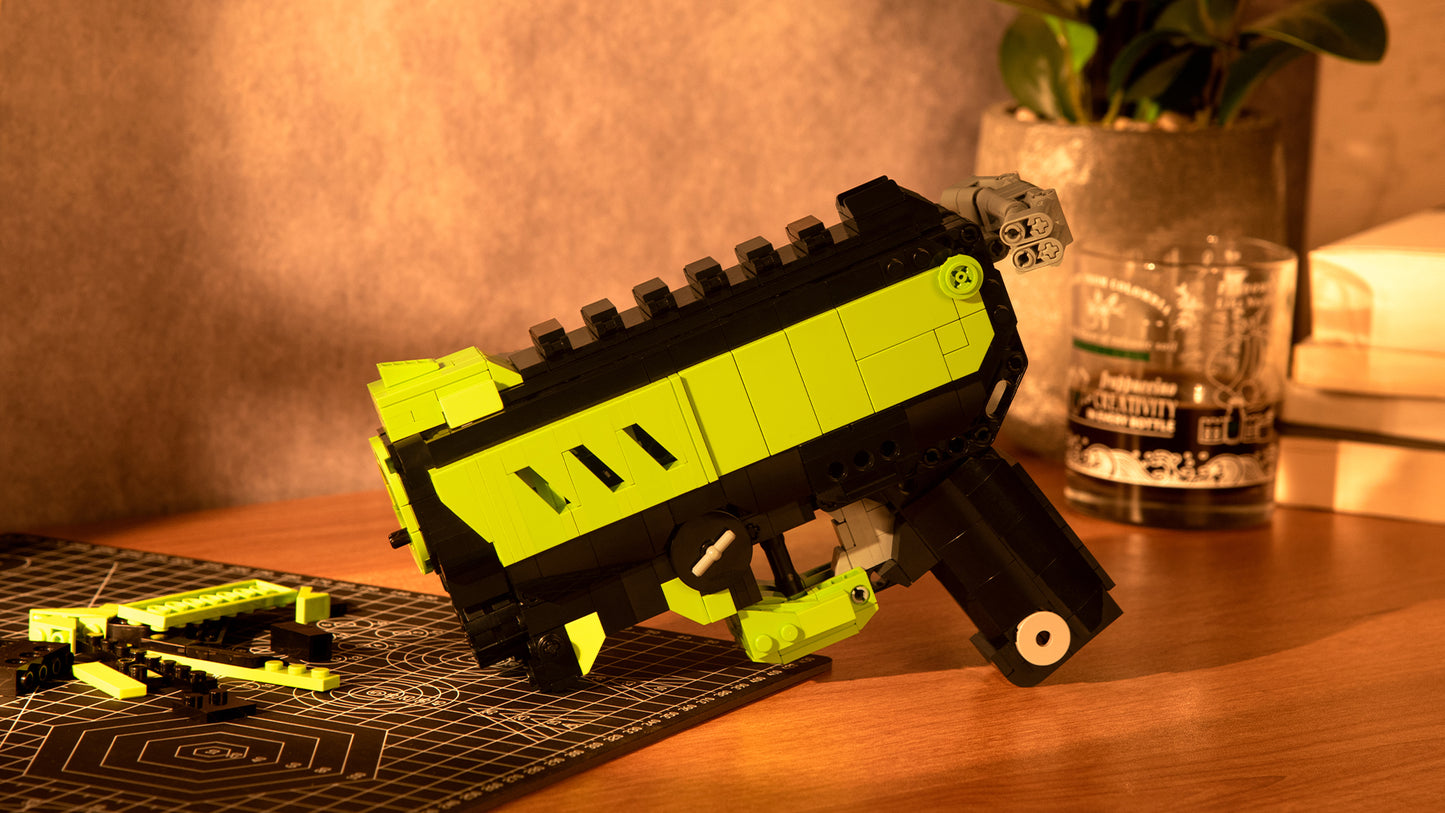 green phantom block gun blaster with scattered block parts on table in sunset