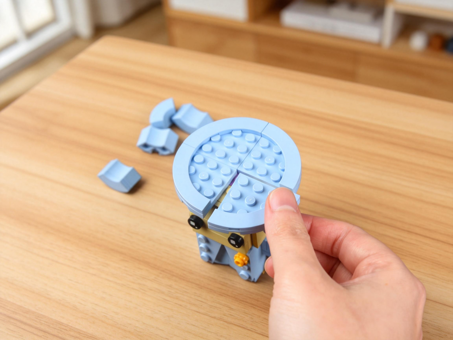 Hand building Bloxday Queen of Blocks' hat on a wooden table